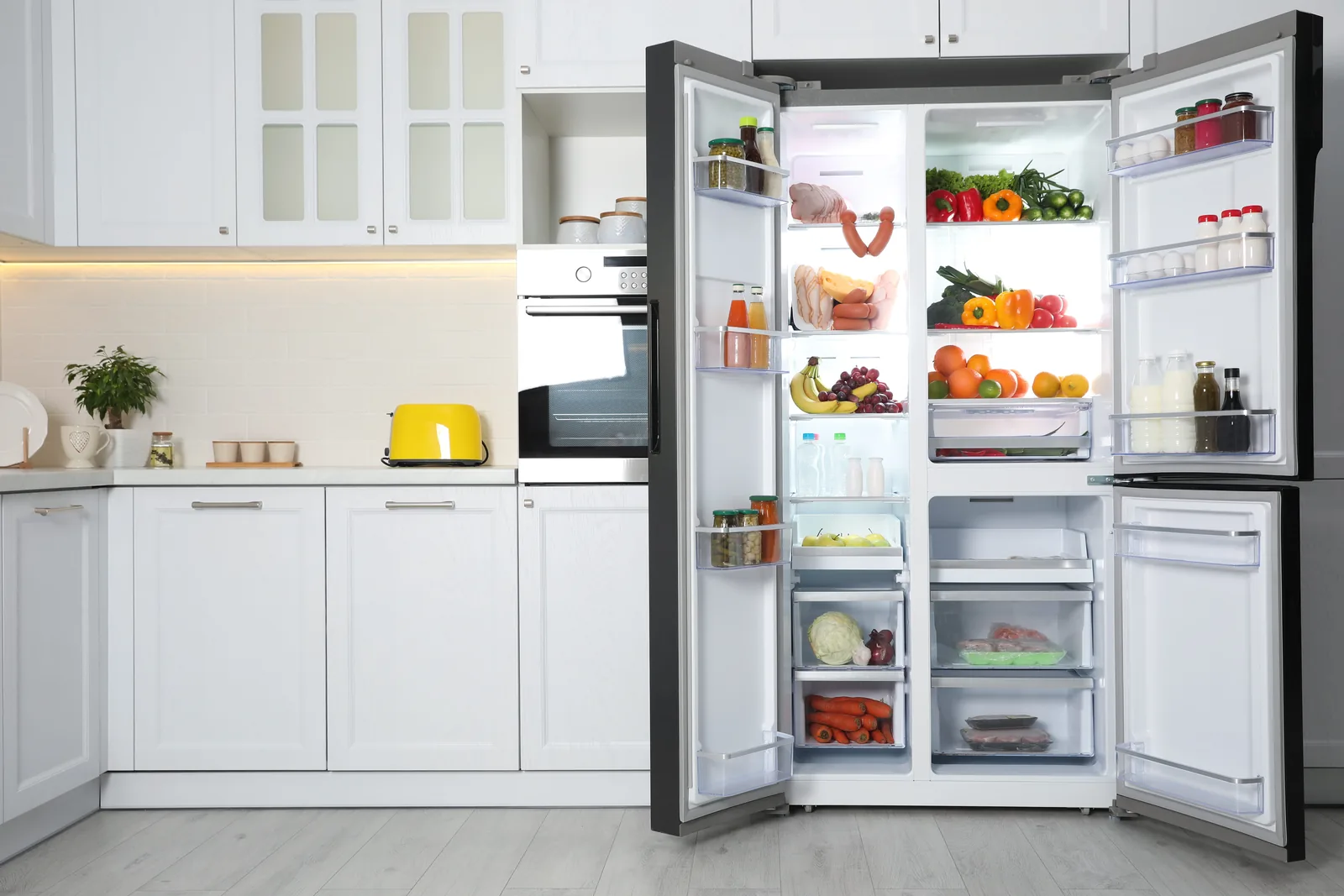 Modern kitchen with a built-in oven beside the fridge-freezer